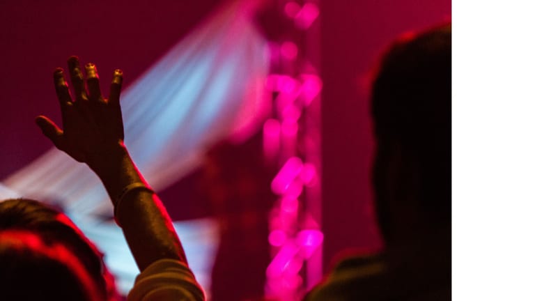 Worship leader playing guitar during a Good Friday church service