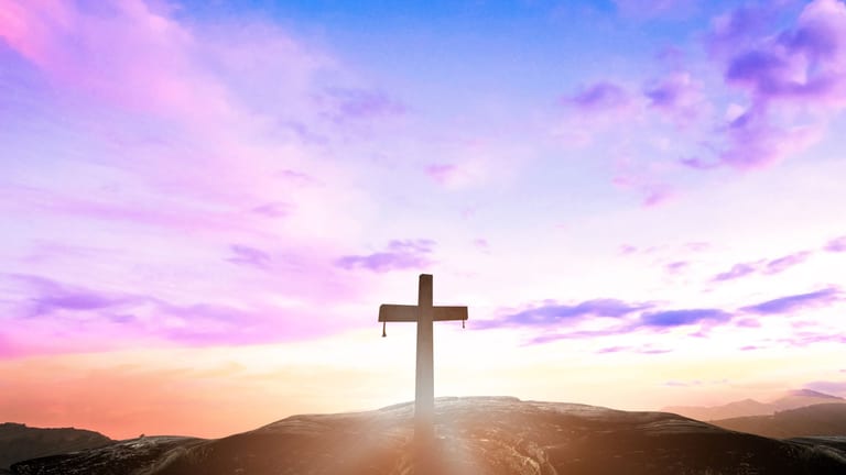 Cross silhouette against a dark sky representing the importance of Good Friday
