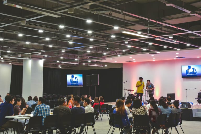 Modern church gathering with stage and community